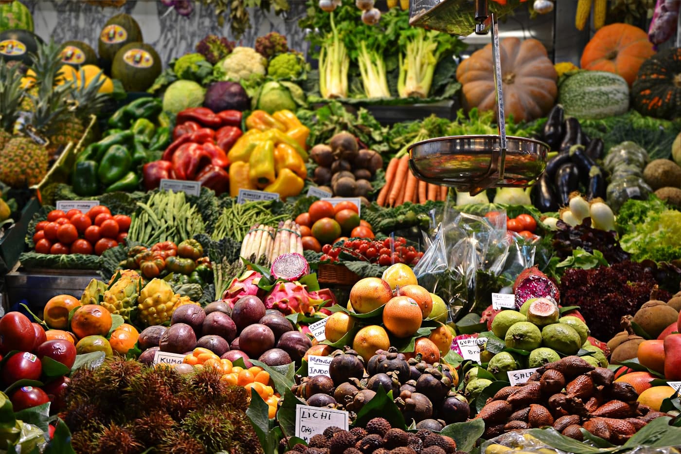 A local farmers market stall piled with fresh seasonal produce